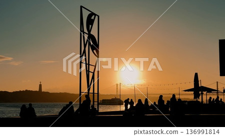 Families and friends share joyful moments during peaceful sunset view Families and friends share joyful moments during peaceful sunset view 136991814