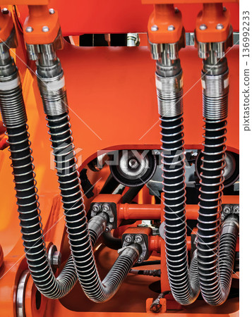 Hydraulic system components in heavy machinery showcasing intricate connections and detailing Hydraulic system components in heavy machinery showcasing intricate connections and detailing 136992233