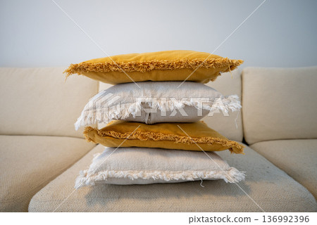 Stack of decorative pillows on sofa in cozy Scandinavian living room Stack of decorative pillows on sofa in cozy Scandinavian living room 136992396