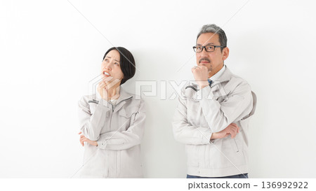 Men and women in work clothes Men and women in work clothes 136992922