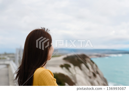 A woman looks at the sea 136993087