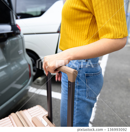 Travel preparations are complete and luggage is moved to the car by car. title: Loading travel luggage into the car 136993092