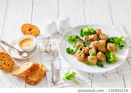 Belgian meatballs in creamy gravy with broccoli and bread 136993234
