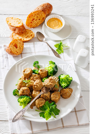 Belgian meatballs in creamy gravy with broccoli and bread Belgian meatballs in creamy gravy with broccoli and bread 136993241