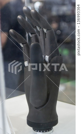 Bionic arm prosthesis. Plastic prosthesis printed on a 3D printer. Robotic arm. Robotics prosthesis for hand printed on a 3D printer from plastic powder. Modern new innovation medicine technologies. Bionic arm prosthesis. Plastic prosthesis printed on a 3D printer. Robotic arm. Robotics prosthesis for hand printed on a 3D printer from plastic powder. Modern new innovation medicine technologies. 136993364