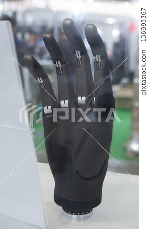 Bionic arm prosthesis. Plastic prosthesis printed on a 3D printer. Robotic arm. Robotics prosthesis for hand printed on a 3D printer from plastic powder. Modern new innovation medicine technologies. 136993367