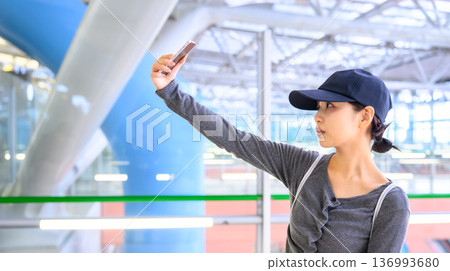 A woman taking a selfie at the station. Photo courtesy of Kansai International Airport (KIX). A woman taking a selfie at the station. Photo courtesy of Kansai International Airport (KIX). 136993680