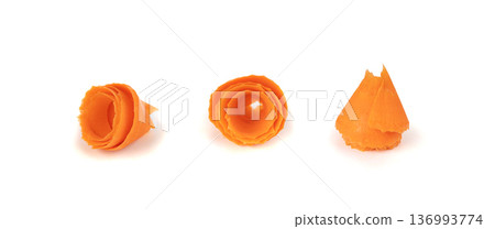 Thin carrot strips swirled in a rose flower shape isolated. Carrot slices for salad decoration Thin carrot strips swirled in a rose flower shape isolated. Carrot slices for salad decoration 136993774