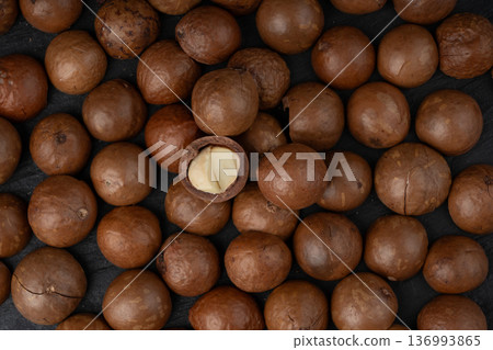 Macadamia nuts pattern. Natural raw peeled macadamia seeds and shells 136993865