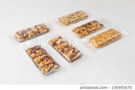 Nut Bar in Plastic Package Isolated, Energy Snack with Nuts, Muesli, Protein Candy Bar, Fitness Fruit Nut Bar in Plastic Package Isolated, Energy Snack with Nuts, Muesli, Protein Candy Bar, Fitness Fruit 136993870