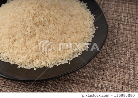 White parboiled rice grains. Dry uncooked ponni rice, small organic basmati White parboiled rice grains. Dry uncooked ponni rice, small organic basmati 136993890