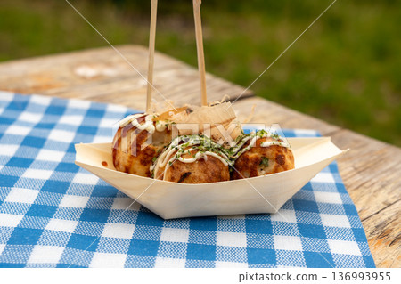 Takoyaki - traditional Japanese street food, outdoor snack with octopus Takoyaki fried balls 136993955