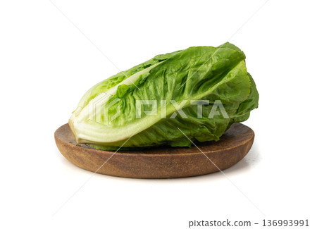 One romaine lettuce salad isolated. Cos green leaves, fresh romain salat head, raw cabbage One romaine lettuce salad isolated. Cos green leaves, fresh romain salat head, raw cabbage 136993991