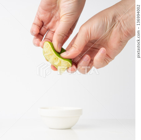 Squeezed lime isolated, squeezed out half green lemon on white background, burnout symbol Squeezed lime isolated, squeezed out half green lemon on white background, burnout symbol 136994002
