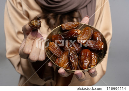 Serene display of glossy dates held during tranquil communal gathering 136994234