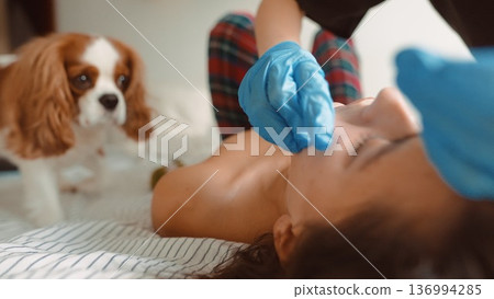 Intimate setting featuring medical interaction and domestic curiosity 136994285