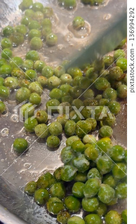 Buttered peas bubble softly amid cozy restaurant atmosphere 136994292