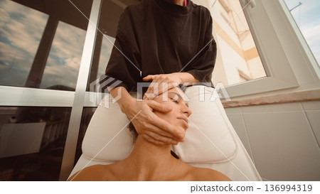 Therapy specialist helps align head and neck to ease facial tension Therapy specialist helps align head and neck to ease facial tension 136994319