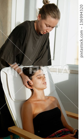 Calming massage enhances skin with soothing sunlight ambiance Calming massage enhances skin with soothing sunlight ambiance 136994320