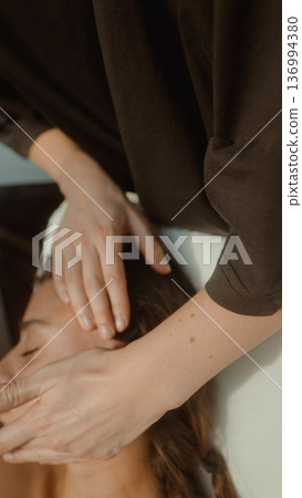 Closeup of massage therapist executing lymphatic drainage technique 136994380
