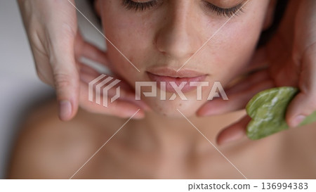 Professional esthetician provides soothing skincare service 136994383