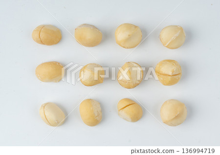 Macadamia nuts isolated. Natural raw peeled macadamia seeds and shells 136994719