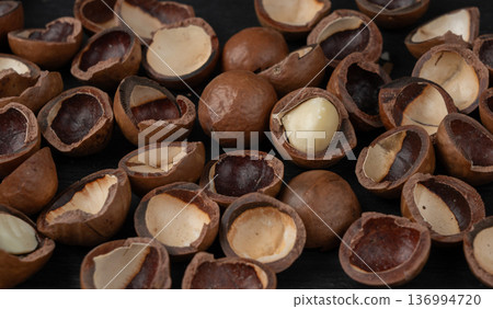 Macadamia nuts pattern. Natural raw peeled macadamia seeds and shells Macadamia nuts pattern. Natural raw peeled macadamia seeds and shells 136994720