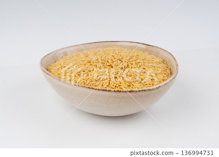 Raw orzo pasta, risoni or kritharaki pile 136994731