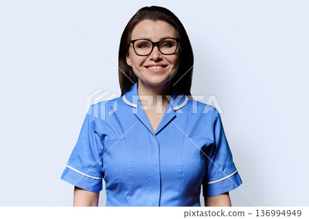 Portrait of mature woman nurse on white studio background Portrait of mature woman nurse on white studio background 136994949