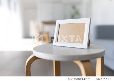 White picture frame and chair 136995372