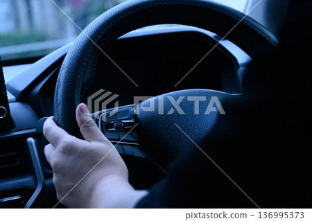 Hand holding handles 136995373