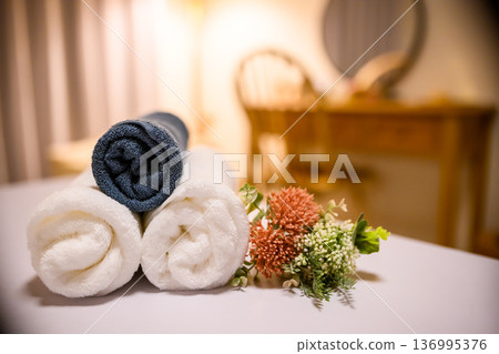Towel and flower decoration 136995376