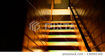 Green light in a dark staircase 136995389