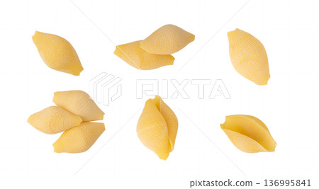 Raw conchiglioni pasta isolated. Dry conchiglie noodle in shell shape, big Italian macaroni Raw conchiglioni pasta isolated. Dry conchiglie noodle in shell shape, big Italian macaroni 136995841