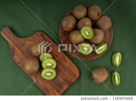 Kiwi fruits slices on wood cutting board 136995868
