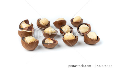 Macadamia nuts isolated. Natural raw peeled macadamia seeds and shells 136995872