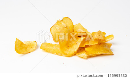 Dry parsnip chips isolated, dried sliced vegetable, healthy crispy Pastinaca sativa snack pile 136995880
