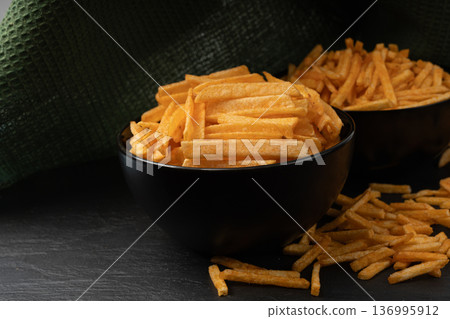 Fried chips sticks, finger potato chips, golden shoestring fries pile, French fries 136995912