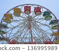 Empty ferris wheel stands still in luna park during daytime hours. 136995989
