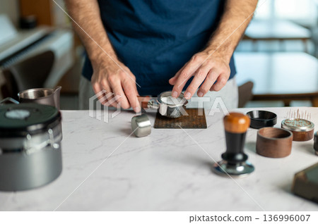 Man Preparing Espresso With Precision At Home Barista Setup 136996007