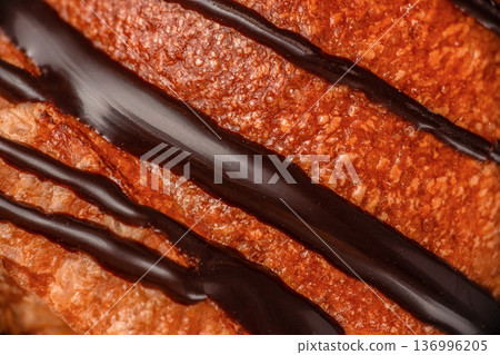 Chocolate drizzle on croissant crust macro texture 136996205