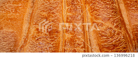 Golden flaky croissant crust texture extreme macro 136996218