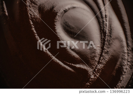 Dark chocolate swirl texture with smooth cocoa surface 136996223