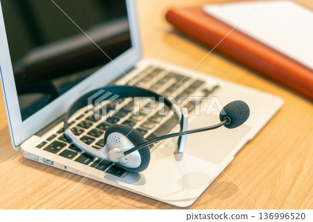 Computer keyboard and headphones 136996520