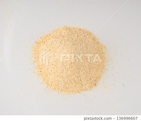 Garlic powder pile isolated, dried granulated chopped crushed garlic on white background Garlic powder pile isolated, dried granulated chopped crushed garlic on white background 136996607