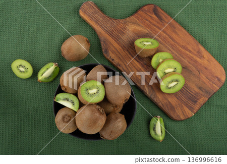 Kiwi fruits slices on wood cutting board Kiwi fruits slices on wood cutting board 136996616