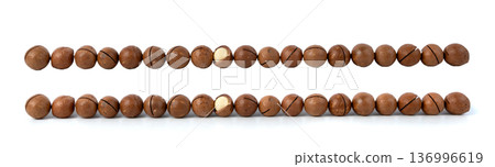 Macadamia nuts isolated. Natural raw peeled macadamia seeds and shells 136996619