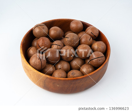 Macadamia nuts isolated. Natural raw peeled macadamia seeds and shells 136996623