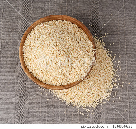 Sesame seeds pile closeup, white small benne grains. Sesamum indicum fruits Sesame seeds pile closeup, white small benne grains. Sesamum indicum fruits 136996655