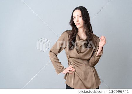 Female beauty doing skin care on a gray background 136996741